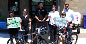 Two grand prize winners of map contest shown with their bikes and architects society members and library ceo